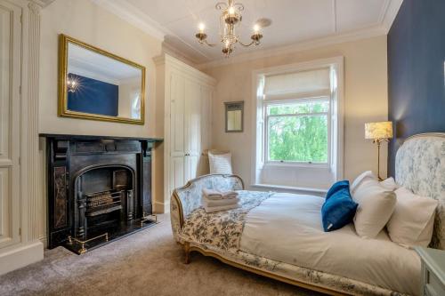 a bedroom with a bed with a fireplace and a mirror at 4 Bed in Beamish oc-o32025 in Beamish