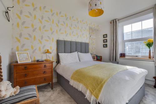 a bedroom with a bed and a dresser and a window at 2 Bed in Skipton oc-ds932 in Skipton