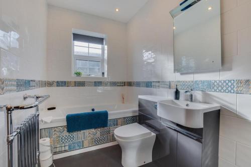 a bathroom with a toilet and a sink and a tub at 2 Bed in Skipton oc-ds932 in Skipton