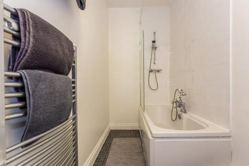 a bathroom with a shower and a tub and a sink at Two Bed Apartment RYTON With Free Parking in Ryton