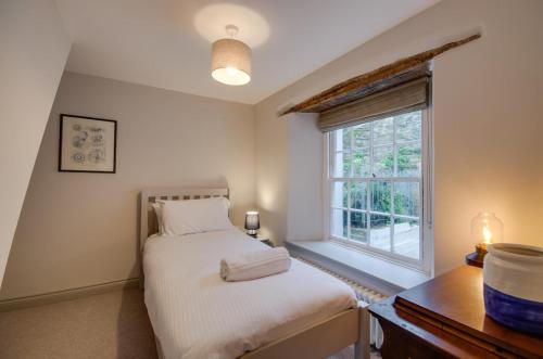 a bedroom with a bed and a window at 3 Bed in Fowey oc-p00871 in Fowey