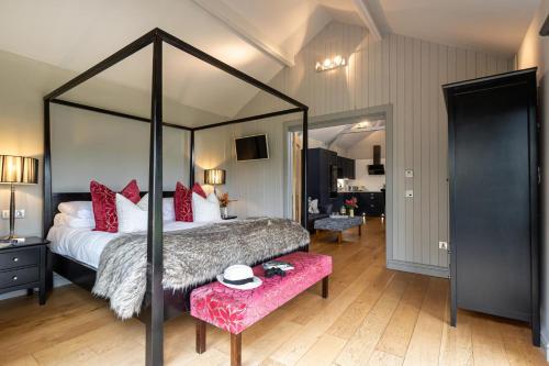 a bedroom with a large canopy bed with a pink bench at 1 Bed in Tunstall oc-p30379 in Tunstall