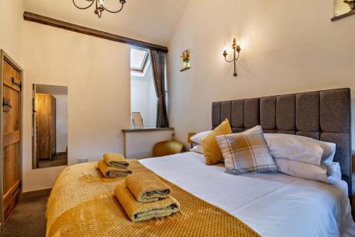 a bedroom with a large bed with towels on it at 2 Bed in Bolam oc-b29967 in Ingleton