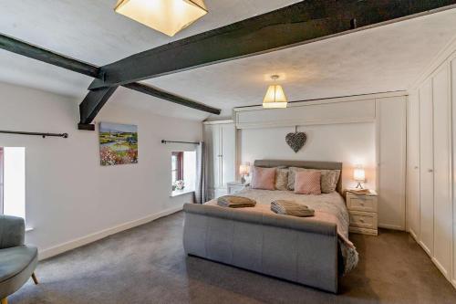 a bedroom with a bed and a couch at 3 Bed in Pentre Bach oc-t30863 in Pentre-bâch
