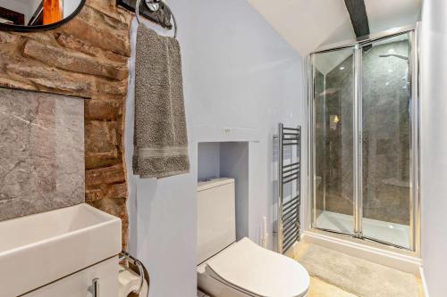 a bathroom with a toilet and a glass shower at 3 Bed in Pentre Bach oc-t30863 in Pentre-bâch