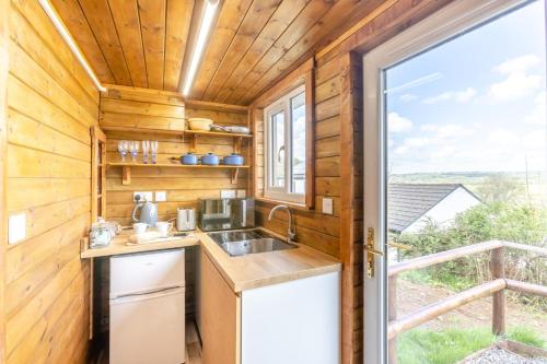 a kitchen in a tiny house with a window at 1 Bed in Latchley oc-l31925 in Sydenham Damerel