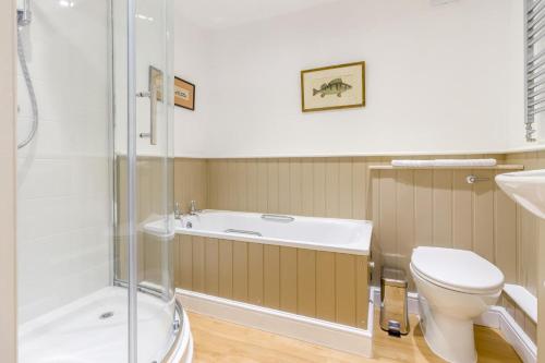 a bathroom with a tub and a toilet and a shower at 2 Bed in Little Hereford oc-l29580 in Berrington