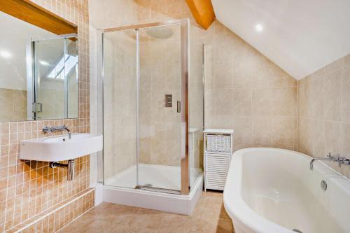 a bathroom with a shower and a tub and a sink at 4 Bed in Nottage oc-t28401 in Nottage