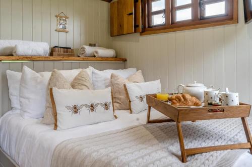 a bed with white pillows and a tray of food on it at 1 Bed in Bronllys oc-t31949 in Bronllys