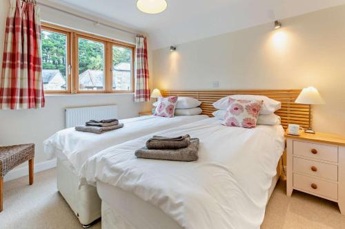 a bedroom with a large white bed with towels on it at 3 Bed in Goldenbank oc-c29977 in Falmouth