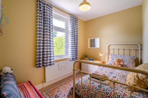 a childs bedroom with a bed and a window at 2 Bed in Dymchurch oc-s31998 in Dymchurch
