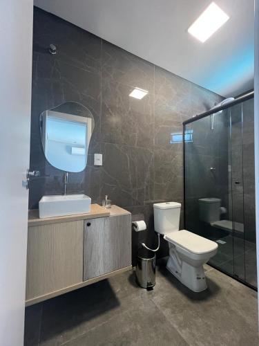 a bathroom with a toilet and a sink and a shower at Pousada Selenita in Ametista do Sul