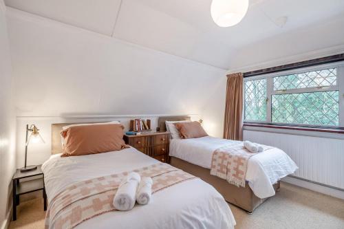 a bedroom with two beds and a window at 2 Bed in Charing oc-r29113 in Charing