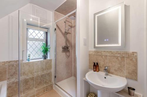 a white bathroom with a sink and a shower at 2 Bed in Charing oc-r29113 in Charing