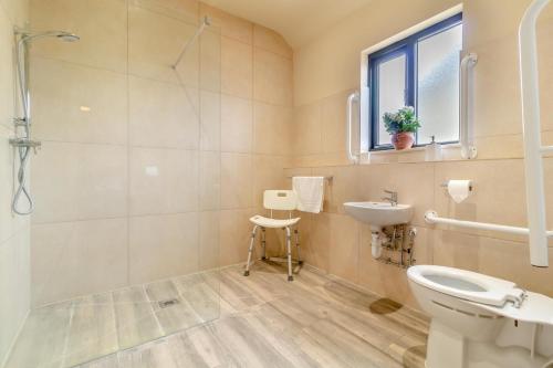 a bathroom with a sink and a toilet and a window at 3 Bed in Heveningham oc-w29031 in Heveningham