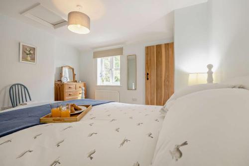 a bedroom with a bed with a tray of oranges on it at 2 Bed in Dersingham oc-b27417 in Dersingham