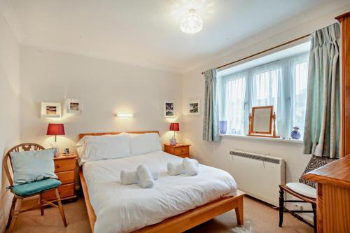 a bedroom with a bed with two towels on it at 3 Bed in Thornham oc-m28084 in Thornham