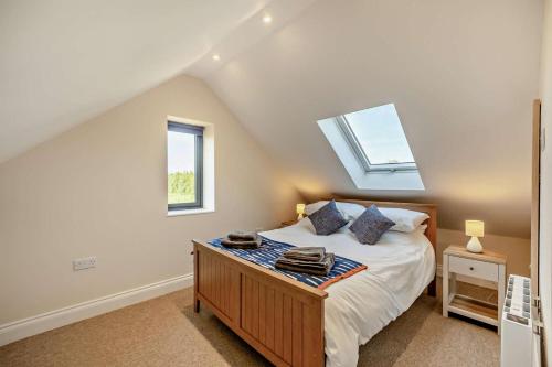 a bedroom with a bed and a skylight at 2 Bed in Feering oc-p29293 in Feering