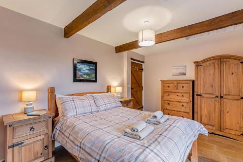 a bedroom with a large bed and a wooden dresser at 2 Bed in Eggleston oc-s30453 in Middleton in Teesdale