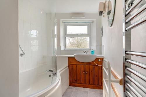 a white bathroom with a sink and a tub and a sink at 2 Bed in Hawes oc-ds1041 in Hawes