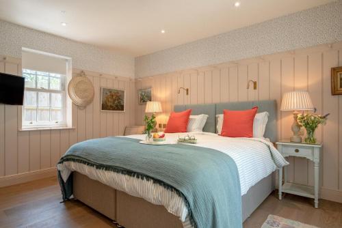 a bedroom with a large bed with red pillows at 3 Bed in Wittersham oc-m27683 in Wittersham
