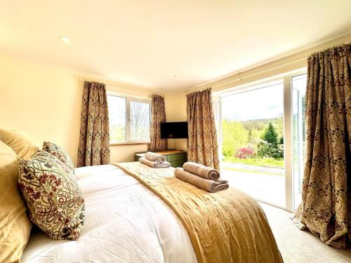 a bedroom with a bed and a large window at 2 Bed in Witheridge oc-b29206 in Witheridge