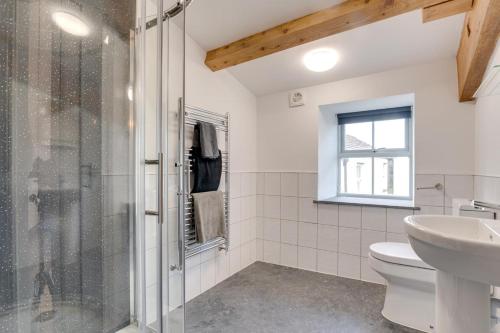 a bathroom with a shower and a toilet and a sink at 3 Bed in Burtersett oc-ds1043 in Hawes