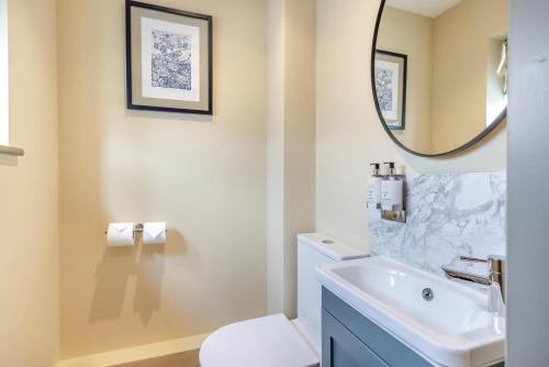 a bathroom with a sink and a toilet and a mirror at 1 Bed in Pershore oc-t29049 in Pershore