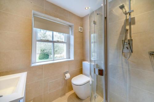 a bathroom with a toilet and a sink and a shower at 2 Bed in Pooley Bridge oc-l31060 in Pooley Bridge