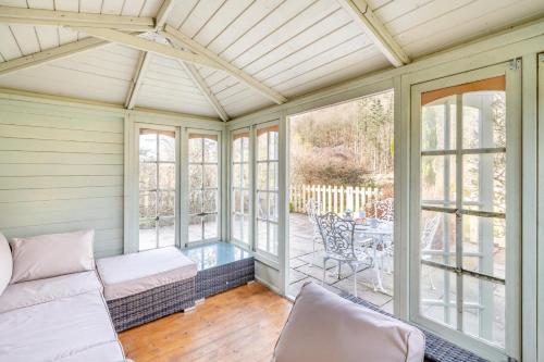 a screened in porch with a couch and a table at 2 Bed in Pooley Bridge oc-l31060 in Pooley Bridge