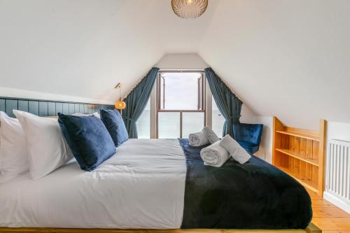 a bedroom with a large bed with towels on it at 3 Bed in Coverack oc-b31082 in Coverack