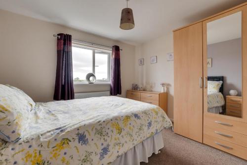 a bedroom with a bed and a dresser and a mirror at 3 Bed in Lucker oc-nb1938 in Lucker