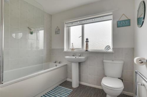 a bathroom with a toilet and a sink and a bath tub at 3 Bed in Lucker oc-nb1938 in Lucker