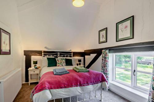 a bedroom with a large bed and a window at 2 Bed in Ilketshall St. Margaret oc-w27520 in Rumburgh