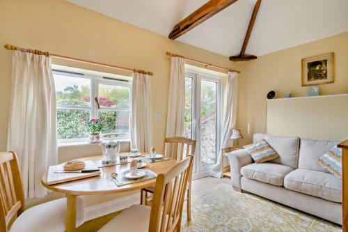 a living room with a table and a couch at 1 Bed in Barton Turf oc-s29126 in Neatishead