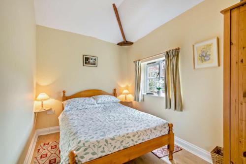a bedroom with a bed and a window at 1 Bed in Barton Turf oc-s29126 in Neatishead