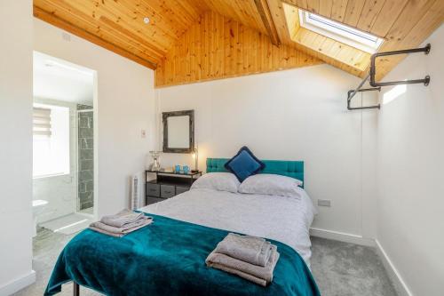 a bedroom with a large bed and a bathroom at 3 Bed in Llysfaen oc-t32226 in Llysfaen