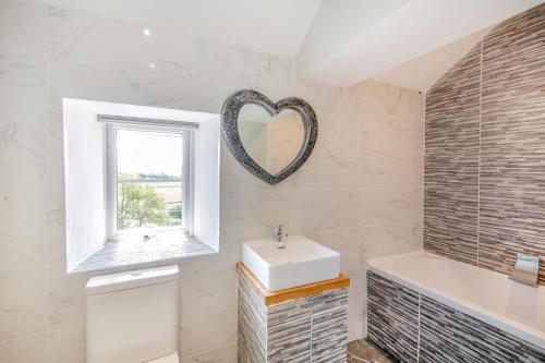 a bathroom with a sink and a mirror on the wall at 3 Bed in Llysfaen oc-t32226 in Llysfaen
