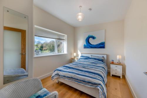 a bedroom with a bed and a window at 2 Bed in Aberdovey oc-n30627 in Aberdyfi