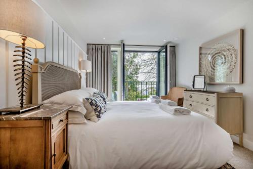 a bedroom with a large white bed and a window at 2 Bed in Padstow oc-h29015 in Padstow
