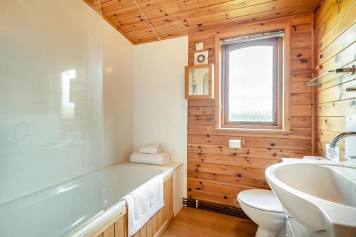 a bathroom with a tub and a toilet and a sink at 2 Bed in Otley oc-slm in Burgh