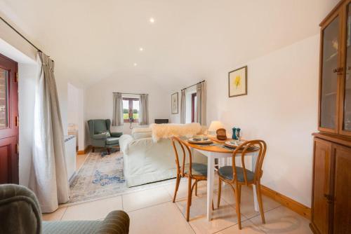 a living room with a table and chairs at 1 Bed in Mautby oc-2302 in Mautby