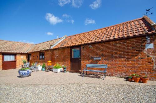 a brick building with a bench in front of it at 1 Bed in Mautby oc-2302 in Mautby