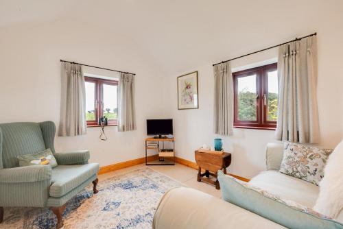 a living room with a couch and a chair at 1 Bed in Mautby oc-2302 in Mautby