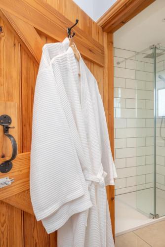 a white towel hanging on a wall in a bathroom at 1 Bed in Mautby oc-2302 in Mautby