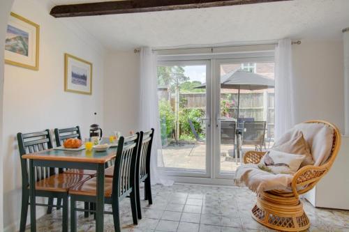 a dining room with a table and chairs and a sliding glass door at 4 Bed in Wiggenhall St. Germans oc-2011 in King's Lynn