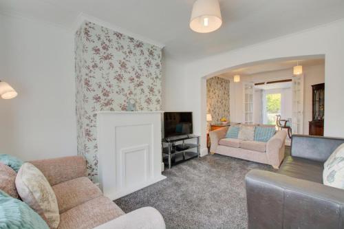 a living room with a couch and a fireplace at 4 Bed in Wiggenhall St. Germans oc-2011 in King's Lynn