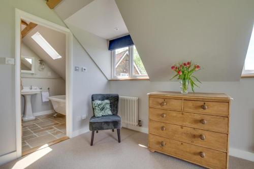 a bathroom with a dresser with a vase of flowers on it at 1 Bed in Wadhurst oc-tw668 in Ticehurst