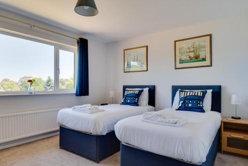 two beds in a room with a window at 3 Bed in Aldeburgh oc-10nw in Aldeburgh