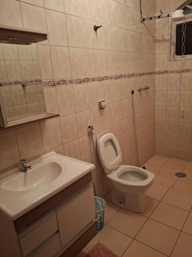 a bathroom with a toilet and a sink at Espaço da Iza in São Pedro